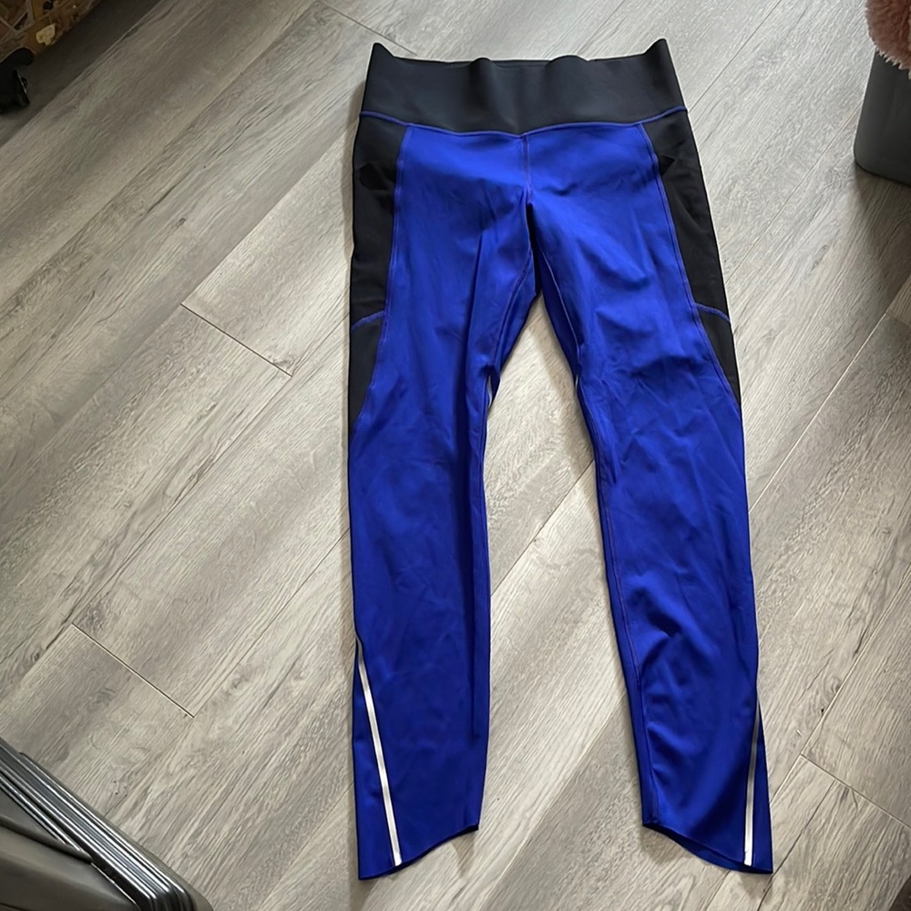 Under Armour compression leggings size large with reflector stripes.
